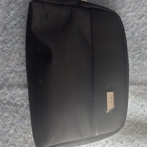 Tumi Black Toiletry Pouch with Silver Logo Plate